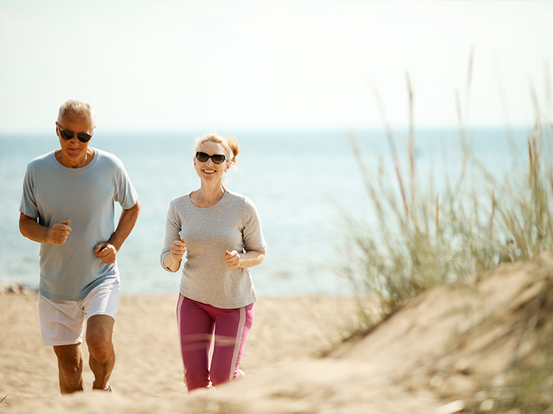 couple jogging on the beach together reasonable rate of return in retirement crystal river fl