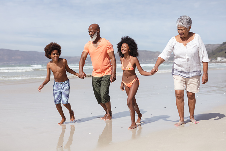 grandparents holding hands with their grandkids while running along the beach shore annuities explained crystal river fl